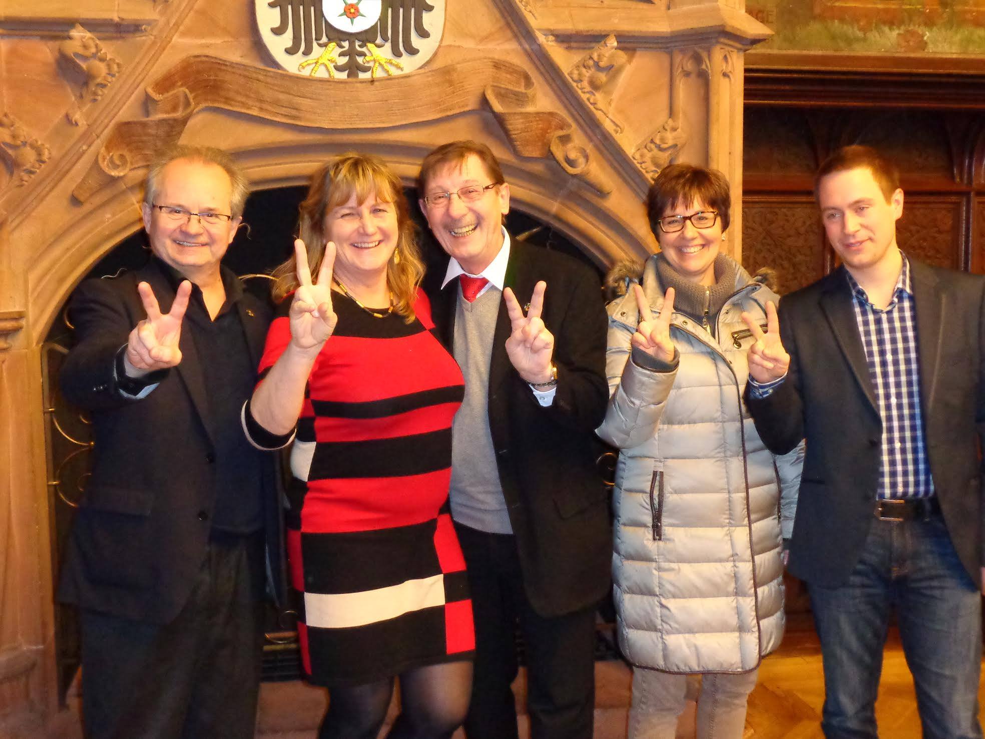 Official image for the Global Tolerance Faces Campaign in the historic town hall of Saarbrücken in Germany. In front of the fireplace are united party-wide from left to right all together to send greetings to the founder Madame Sabine Balve, who was born in Saarbruecken
